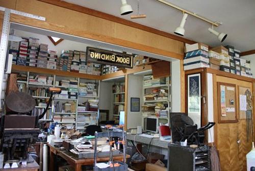 Book Binding nook located in the Literary House filled with papers and books and antique letter presses